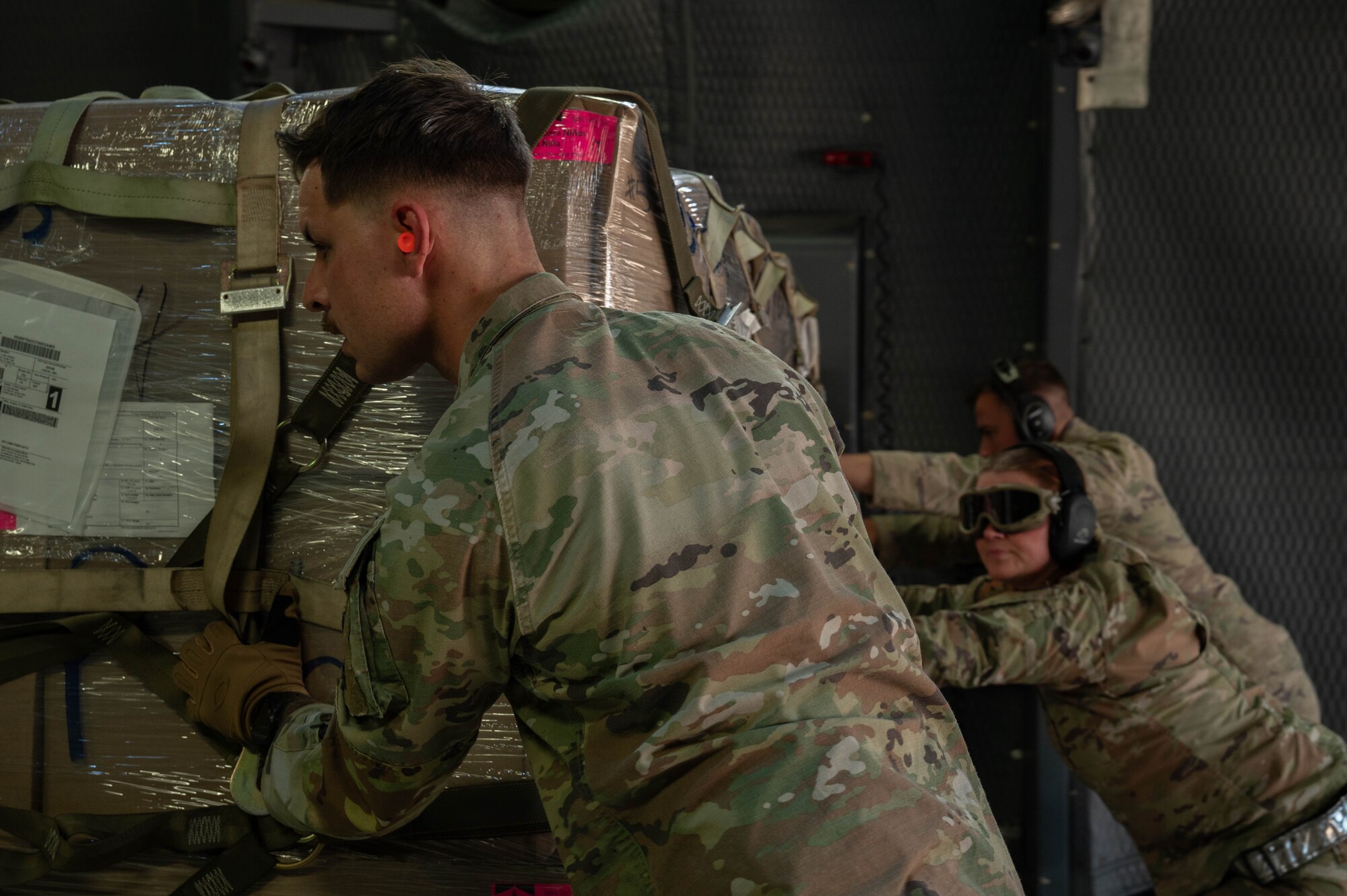 U.S. Air Force Airmen from the 7th Logistics Readiness Squadron air transportation function load cargo onto a C-5M Super Galaxy from the 68th Airlift Squadron, Joint-Base San Antonio-Lackland, Texas, at Dyess Air Force Base, Texas, Jan. 16, 2025. The 7th LRS staged 35,730 pounds of rice to transport to Honduras and El Salvador for humanitarian aid, providing commodities directly to families who struggle with food insecurity. (U.S. Air Force photo by Senior Airman Alondra Cristobal Hernandez)