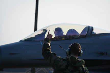 Airman 1st Class Layne Veldhuizen, 35th Fighter Generation Squadron assistant dedicated crew chief, sends the unit motto designation “Push It Up” to U.S. Air Force Capt. Tom Marron, 35th Fighter Squadron F-16 Fighting Falcon pilot, prior to taxiing at Gwangju Air Base during Exercise Beverly Pack 25-1, Republic of Korea, Jan. 14, 2025.