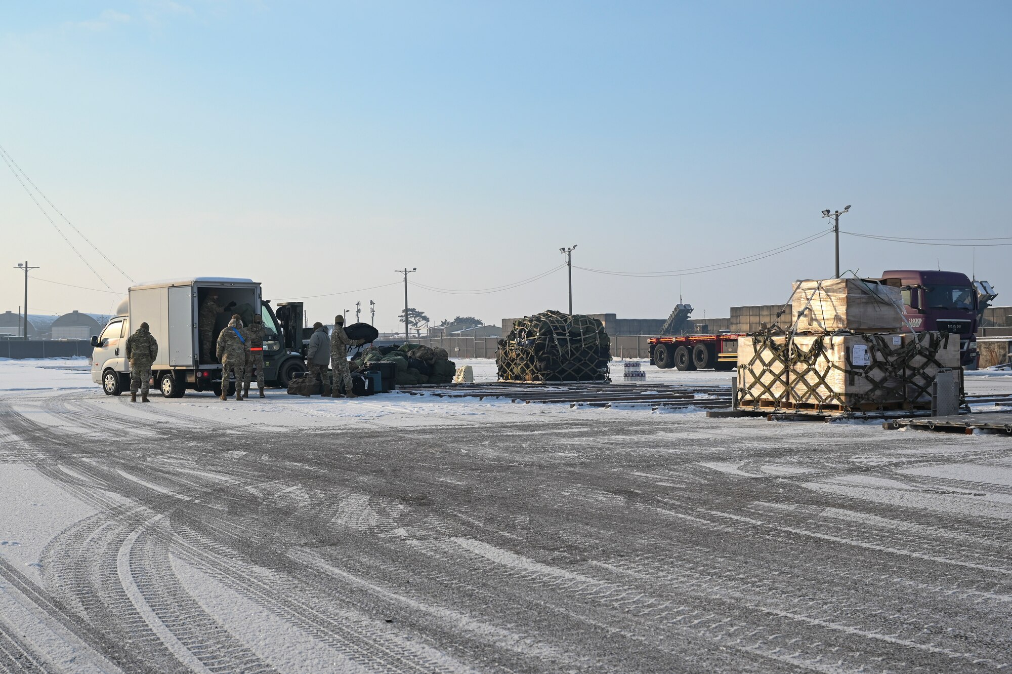 Airmen assigned to the 8th Logistics Readiness Squadron unload cargo from a vehicle during a cargo deployment function line during Beverly Pack 25-1.