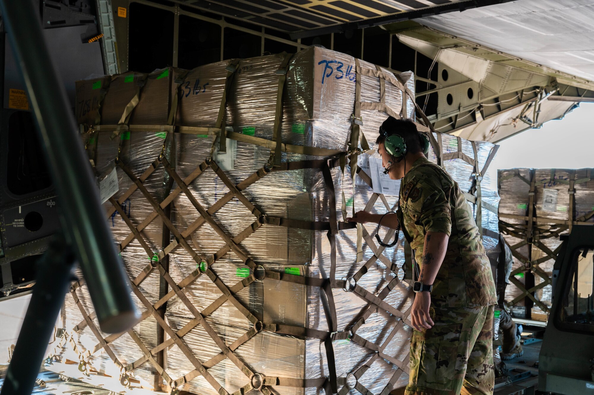 U.S. Air Force Senior Airman Sean Dickerson, 68th Airlift Squadron loadmaster, loads cargo onto a C-5M Super Galaxy from the 68th AS, Joint Base San Antonio-Lackland, Texas, at Dyess Air Force Base, Texas, Jan. 16, 2025. The 7th Logistics Readiness Squadron air transportation function transported 35,730 pounds of rice to Honduras and El Salvador for humanitarian aid. (U.S. Air Force photo by Senior Airman Alondra Cristobal Hernandez)