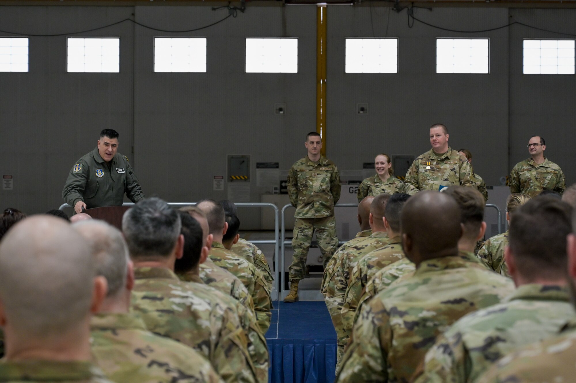 Airmen listen to Wing commander commend fellow Airman for assisting with medical emergency
