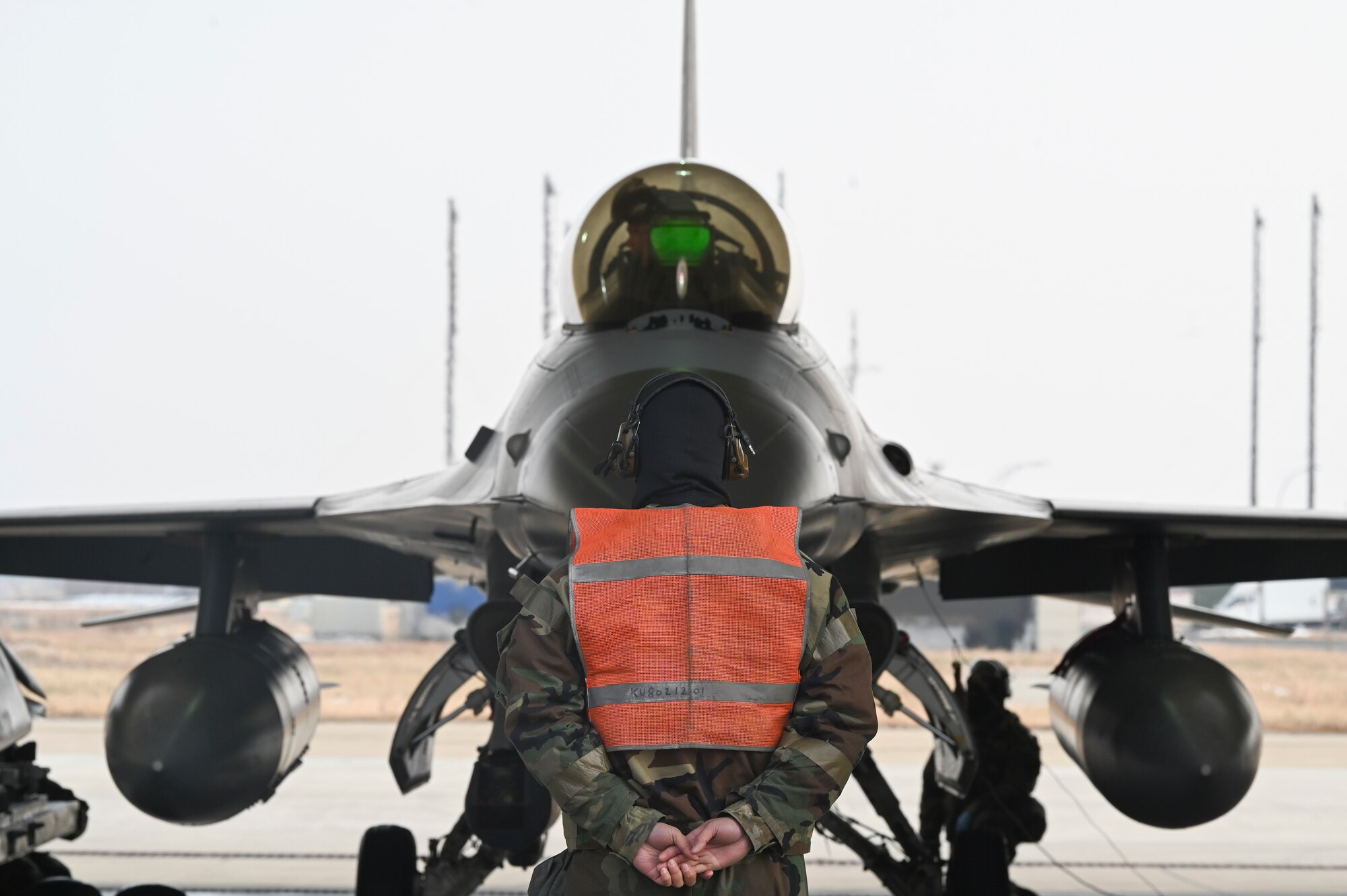 U.S. Air Force Staff Sgt. Nelson Lumibao, 35th Fighter Generation Squadron F-16 Fighting Falcon dedicated crew chief, prepares to marshal an F-16 Fighting Falcon aircraft during Beverly Pack 25-1.