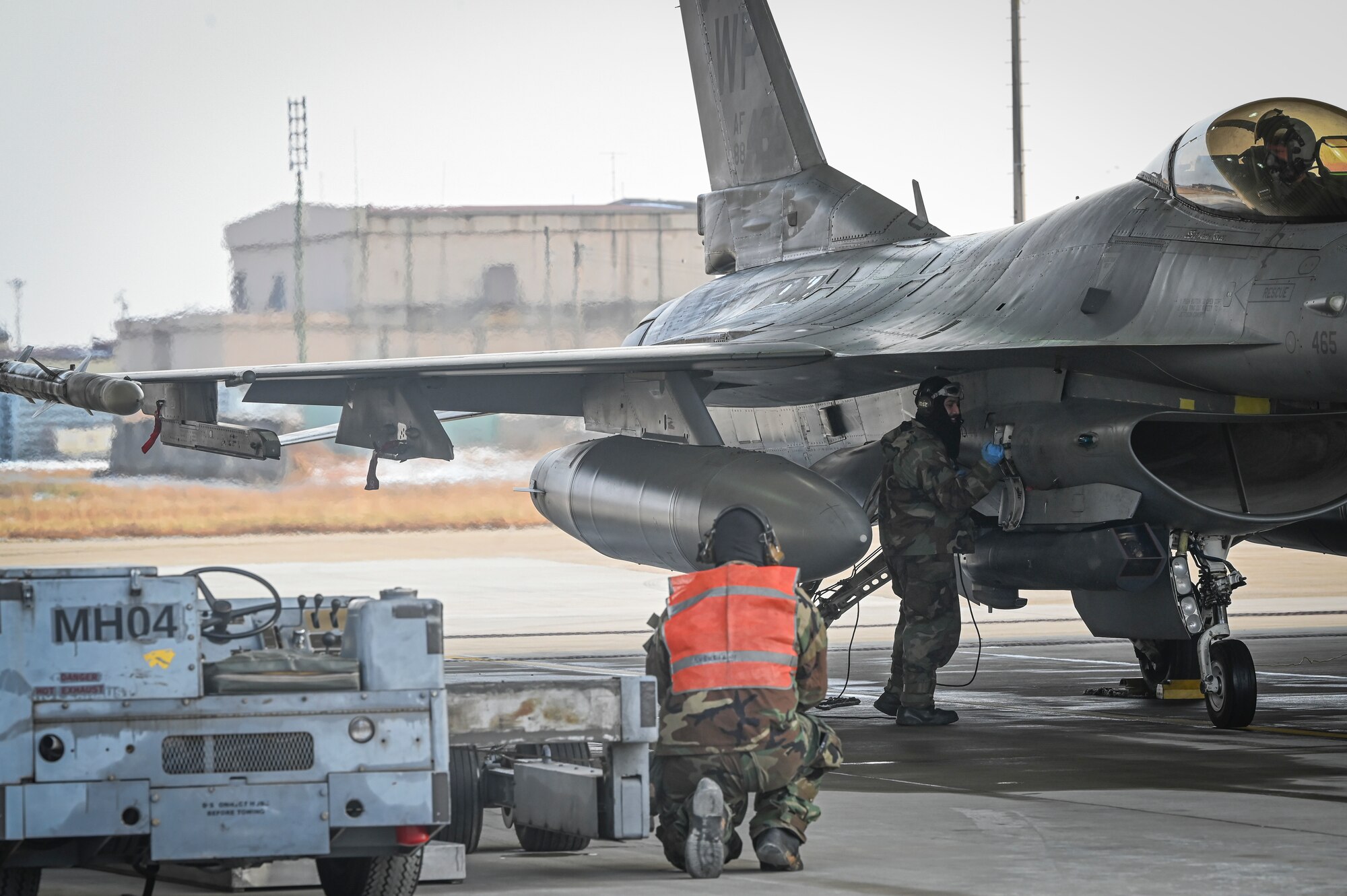U.S. Air Force Staff Sgt. Nelson Lumibao, left, observes Senior Airman Bryson Palmer, 35th Fighter Generation Squadron F-16 Fighting Falcon dedicated crew chiefs, as he conducts maintenance on an F-16 Fighting Falcon aircraft during Beverly Pack 25-1.