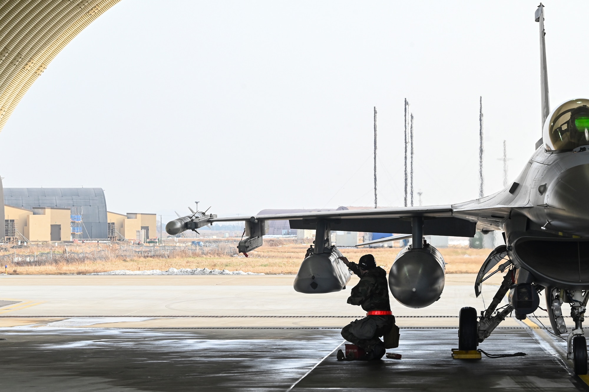 U.S. Air Force Staff Sgt. Joshua Denice, 35th Fighter Generation Squadron loads a Joint Air-to-Surface Standoff Missile on an F-16 Fighting Falcon aircraft during Beverly Pack 25-1.