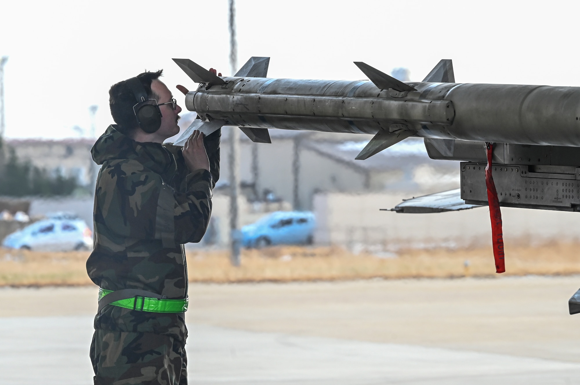 U.S. Air Force Staff Sgt. Jakob Raisanen, 8th Maintenance Group squadron lead crew chief, postloads a missile during Beverly Pack 25-1.