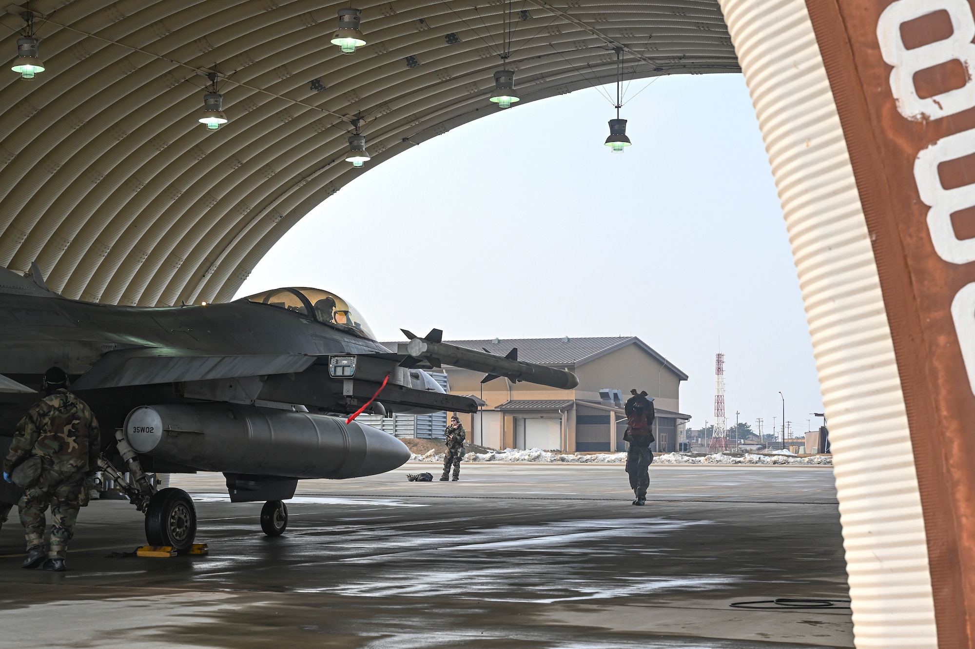 U.S. Air Force Staff Sgt. Nelson Lumibao, 35th Fighter Generation Squadron F-16 Fighting Falcon dedicated crew chief, marshals an F-16 Fighting Falcon aircraft into a flow through during Beverly Pack 25-1.