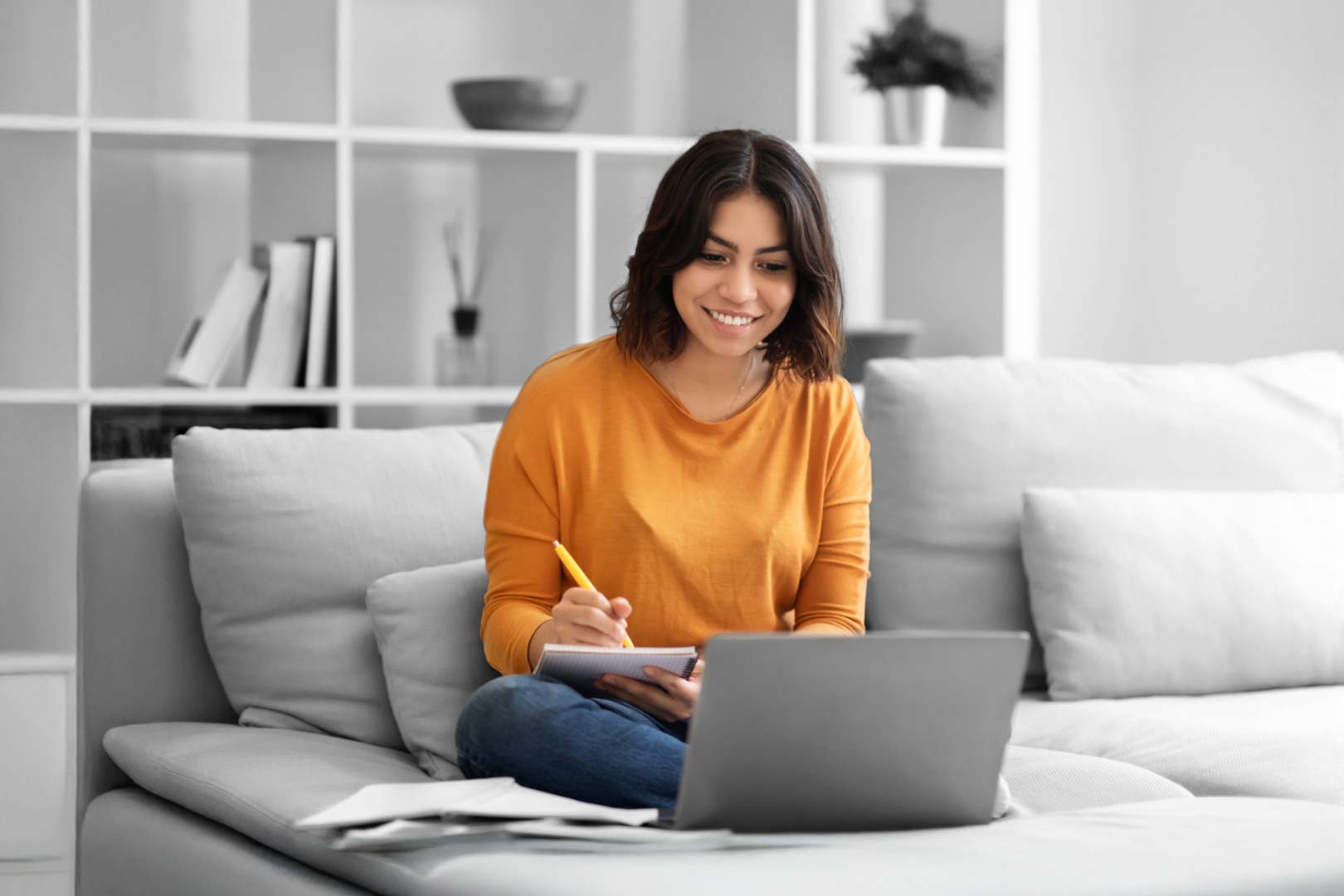 Woman works on a laptop.