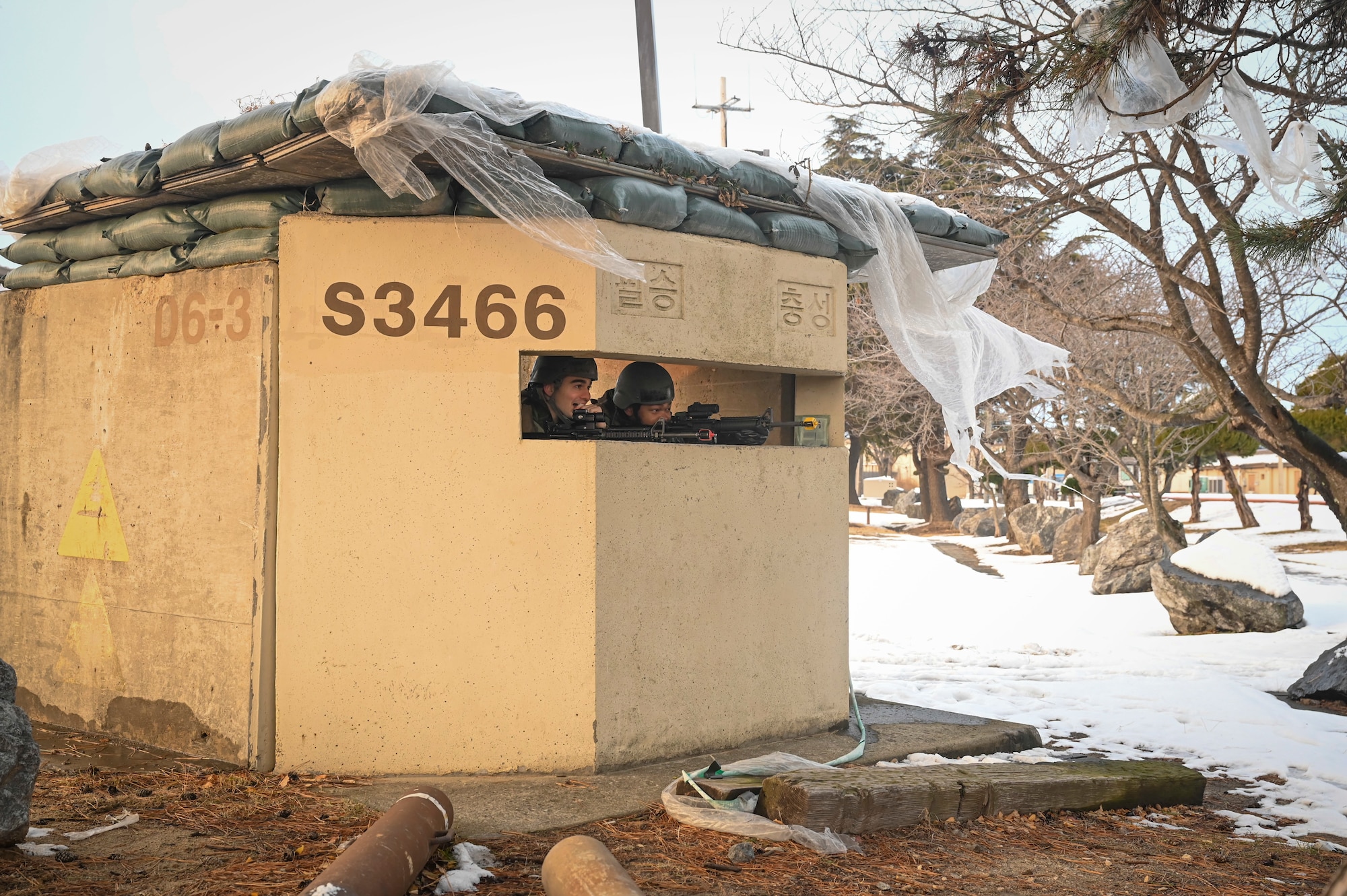 Senior Airman Anthony Newton, left, and Senior Airman Christian Jackson, 8th Comptroller Squadron financial comptroller management journeymen, post at their defensive fighting position during Beverly Pack 25-1.