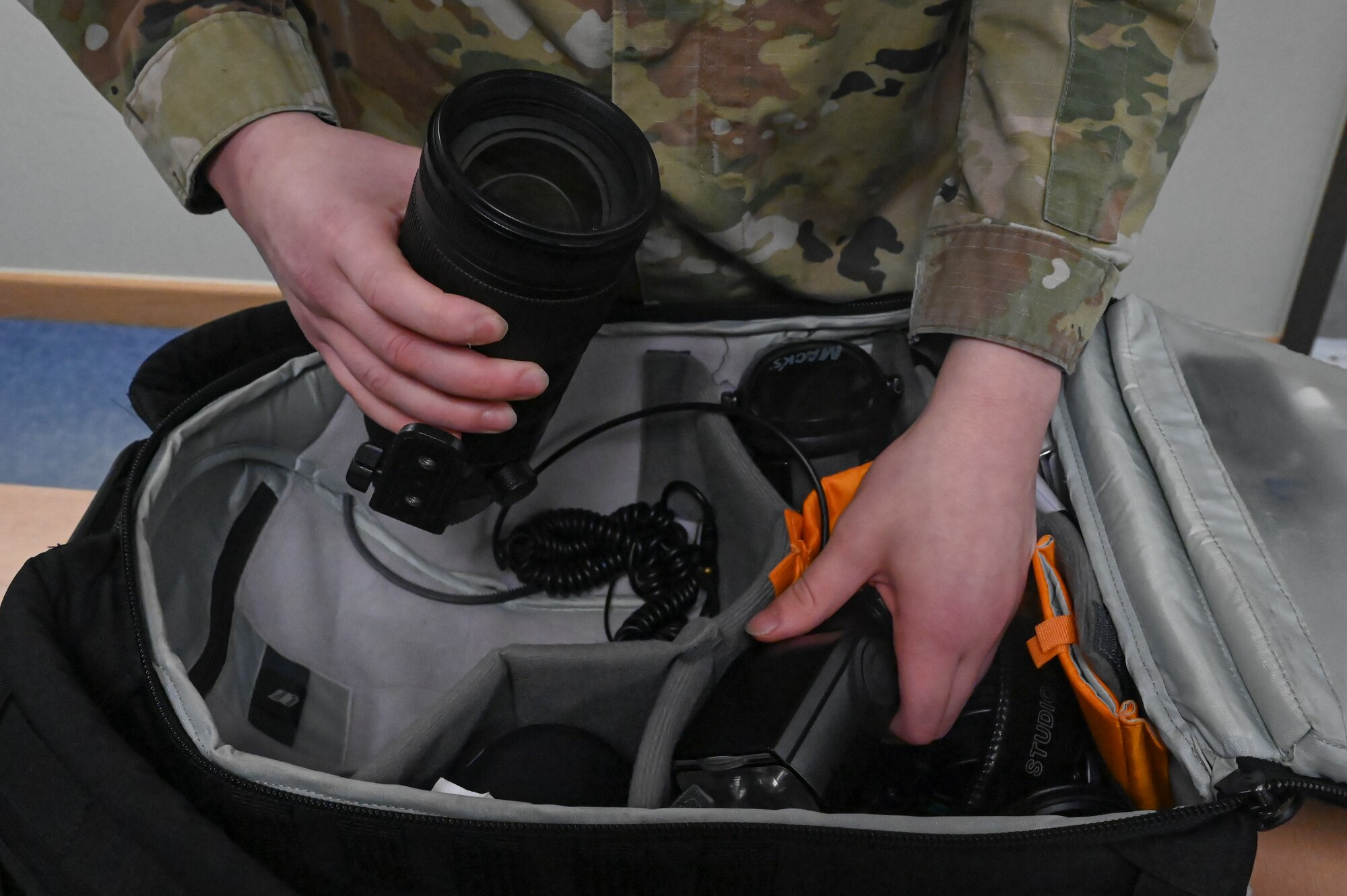Senior Airman James Johnson, 8th Fighter Wing public affairs journeyman, prepares his camera kit equipment.