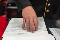 Hand is braced against a music sheet