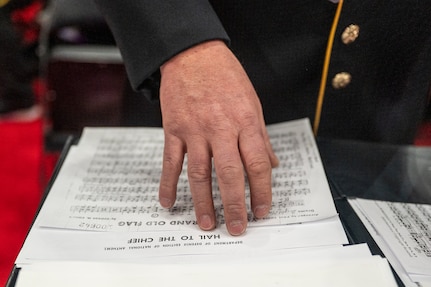 Hand is braced against a music sheet