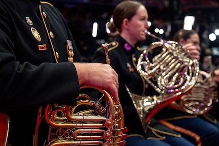 A close up of a Soldier holding their instrument in their lap