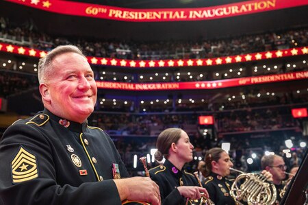 A band member smiles while waiting to perform