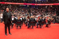 wide shot of band members with security member standing behind them