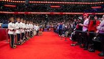 line of trumpet players stand across from audience