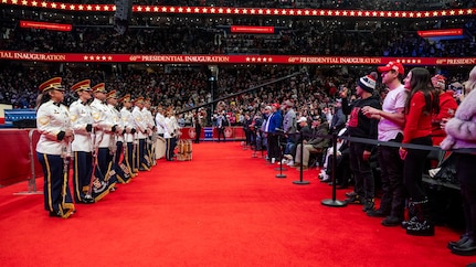 line of trumpet players stand across from audience