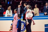 Vice President Vance walks with his family onto the stage waving
