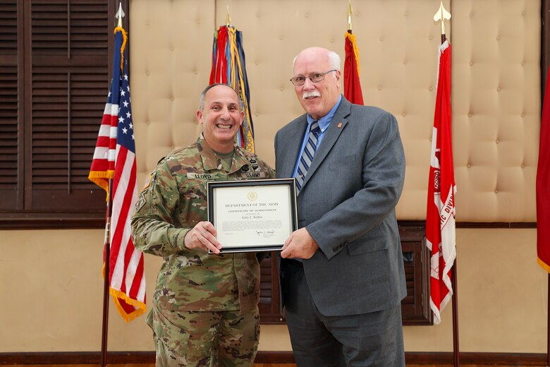 Brig. Gen. John P. Lloyd, U.S. Army Corps of Engineers, North Atlantic Division commander and division engineer, presents Gary L. Kehoe, a retired NAD chief security officer, with a Certificate of Achievement during an all-hands ceremony at the Fort Hamilton Community Club in Brooklyn, New York. During the event, Kehoe was inducted into the NAD Gallery of Distinguished Civilians after a 26-year federal career, becoming the 26th inductee selected for the honor since the gallery’s inception in the mid-1900s.