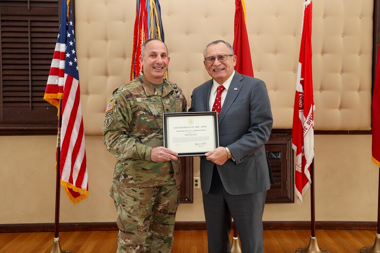 Brig. Gen. John P. Lloyd, U.S. Army Corps of Engineers, North Atlantic Division commander and division engineer, presents Paul Giovinco, a retired NAD regional management board executive director, with a Certificate of Achievement during an all-hands ceremony at the Fort Hamilton Community Club in Brooklyn, New York. During the event, Giovinco was inducted into the NAD Gallery of Distinguished Civilians after a 38-year federal career, becoming the 27th inductee selected for the honor since the gallery’s inception in the mid-1900s.