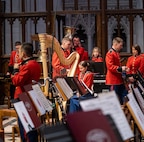 Band members move around seats getting equipment ready
