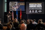 Col. Shane Riley, director, Oklahoma National Guard Unmanned Aerial Systems and Launched Effects Program, welcomes attendees to the second annual OKNG UAS/LE Symposium at the Oklahoma State University Hamm Institute for American Energy in Oklahoma City, Jan. 21, 2025. Topics at the symposium included emerging UAS threats, Department of Defense and National Guard integration in advanced air mobility, maneuver training, integrating UAS in interagency operations, and counter-UAS initiative development. (Oklahoma National Guard photo by Anthony Jones)