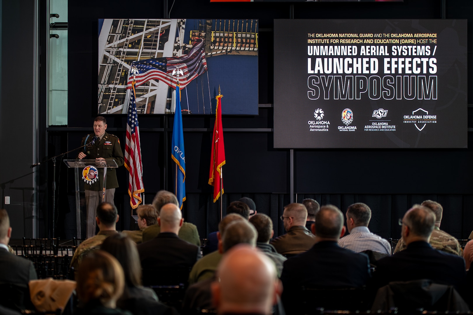 Col. Shane Riley, director, Oklahoma National Guard Unmanned Aerial Systems and Launched Effects Program, welcomes attendees to the second annual OKNG UAS/LE Symposium at the Oklahoma State University Hamm Institute for American Energy in Oklahoma City, Jan. 21, 2025. Topics at the symposium included emerging UAS threats, Department of Defense and National Guard integration in advanced air mobility, maneuver training, integrating UAS in interagency operations, and counter-UAS initiative development. (Oklahoma National Guard photo by Anthony Jones)