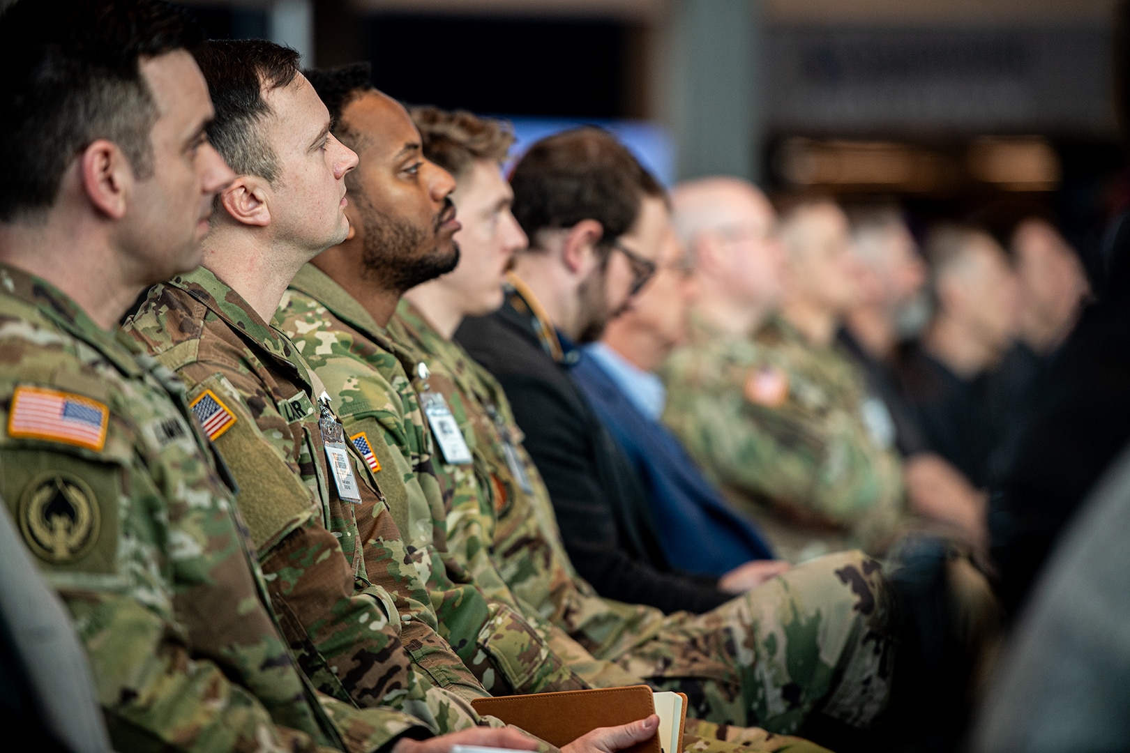 U.S. military personnel, Department of Defense civilians and industry partners listen to a presentation during the second annual OKNG UAS/LE Symposium at the Oklahoma State University Hamm Institute for American Energy in Oklahoma City, Jan. 21, 2025. Topics at the symposium included emerging UAS threats, Department of Defense and National Guard integration in advanced air mobility, maneuver training, integrating UAS in interagency operations, and counter-UAS initiative development. (Oklahoma National Guard photo by Anthony Jones)