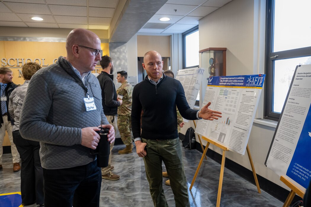 Air Force Institute of Technology students demonstrate their research to attendees for the first Digital Material Management Symposium Jan. 16, 2024, Wright-Patterson Air Force Base, Ohio. The DMM Symposium is vital to showcase student research conducted by AFIT to support various industry partners and program offices within Air Force Materiel Command. (U.S Air Force Photo by Jack Gardner.)