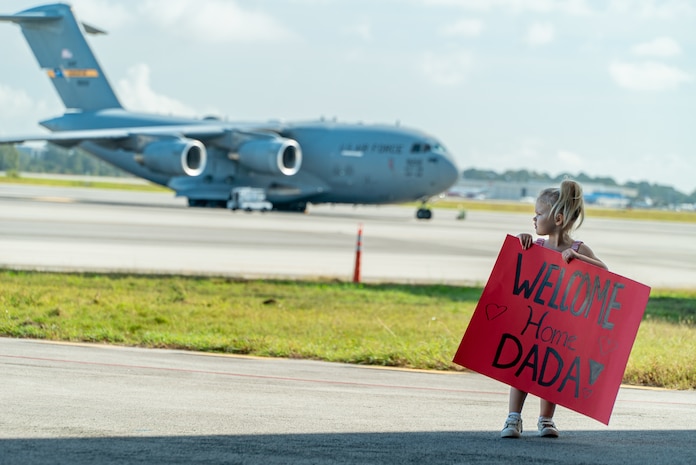 girl holds sign