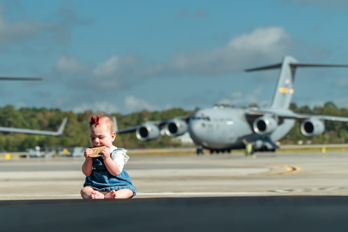 infant sits on flightline