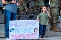 boy holds sign