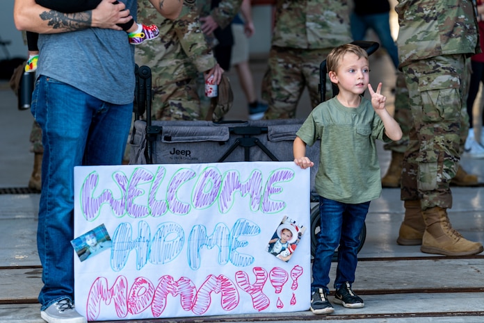 boy holds sign