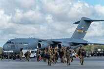 Airmen walk off aircraft