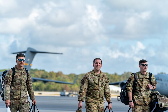 men walk on flightline