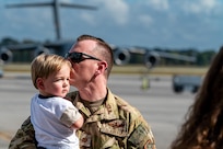 man kisses child