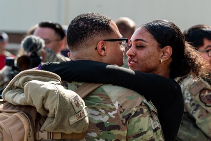 man hugs woman