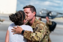 man kisses woman