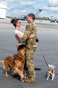 man hugs woman