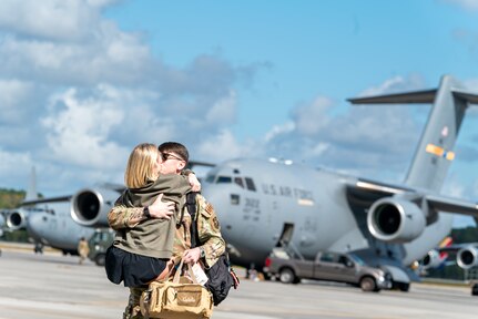 man hugs woman