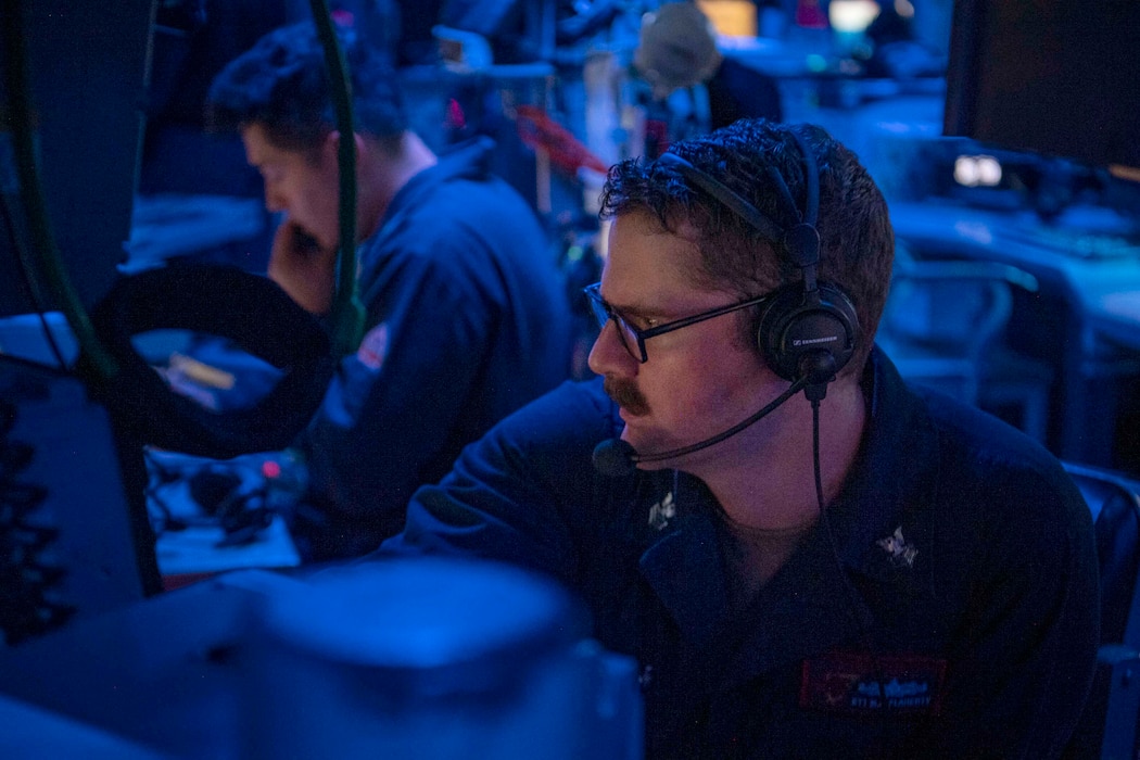 ET1 Michael Flaherty stands watch in the combat information center aboard USS Sterett (DDG 104) in the South China Sea.