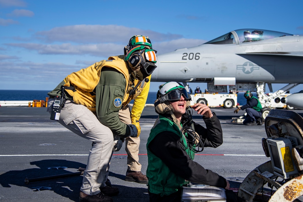 Sailors discuss safety precautions prior to launching aircraft aboard  USS Nimitz (CVN 68) during flight operations in the Pacific Ocean.