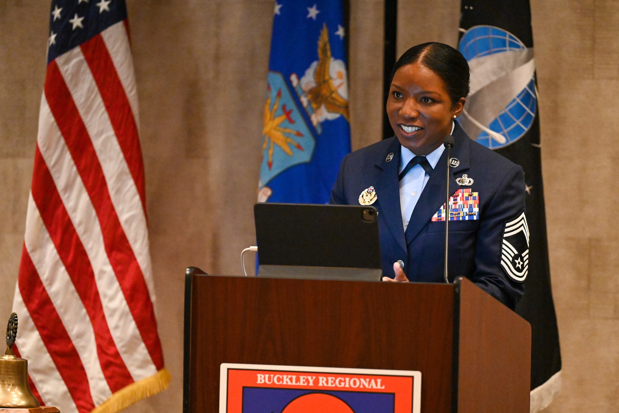 an individual stands at a podium addressing an audience