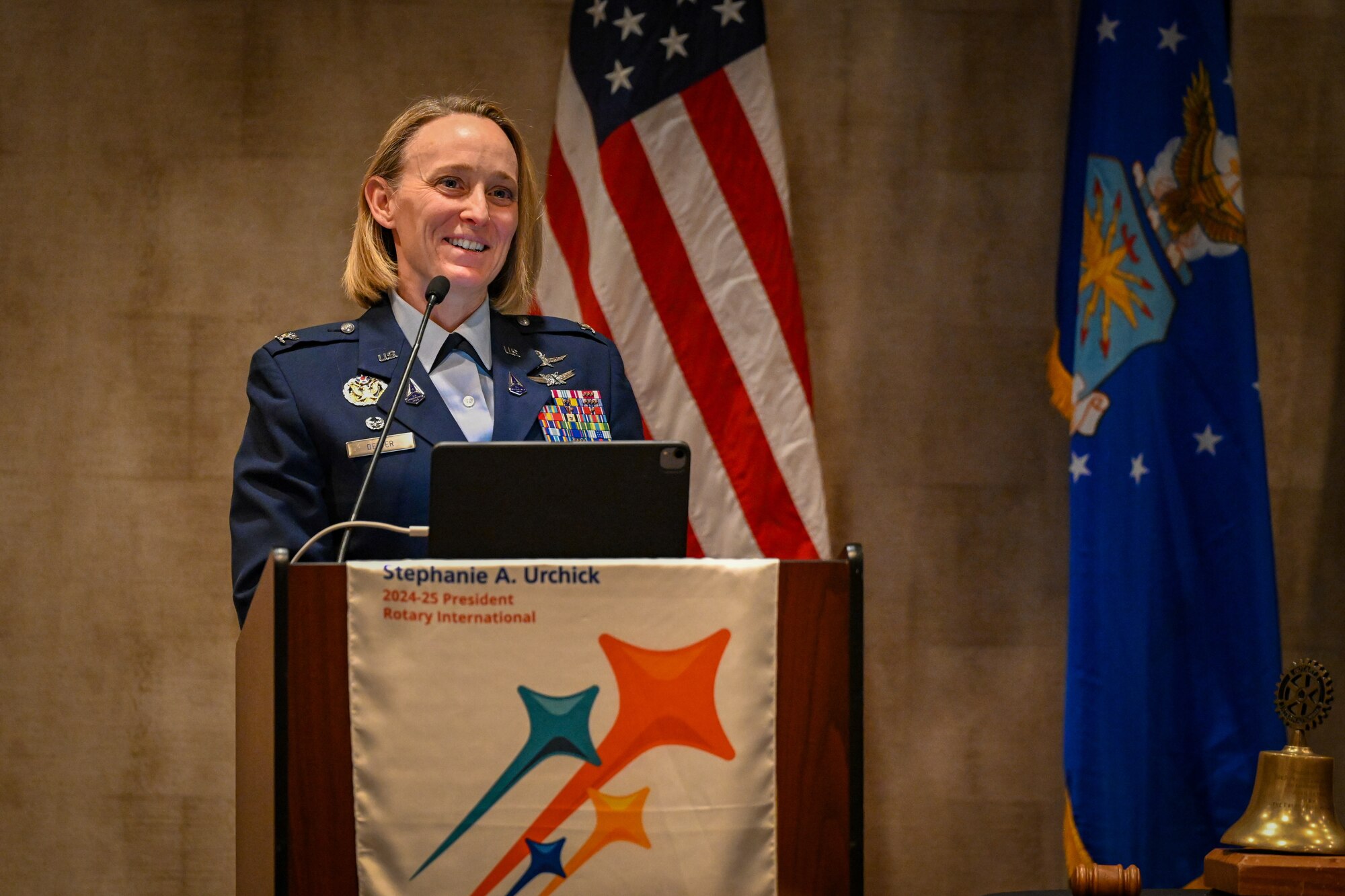 an individual stands at a podium addressing an audience