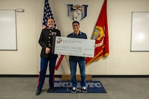 U.S. Marine Corps Capt. Brianna K. LeCompte, the executive officer of Recruiting Station Austin, poses for a picture with Moises Aguirre after the presentation of the Naval Reserve Officer Training Corps scholarship at Hendrickson High School in Pflugerville, Texas, Jan. 15, 2025. Students selected for this prestigious scholarship program must uphold strict physical standards and successfully complete additional military courses while maintaining normal college coursework responsibilities. (U.S. Marine Corps photo by Cpl. Jose D. Cruz)