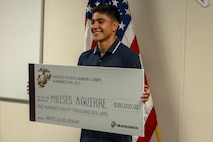 Moises Aguirre, a Hendrickson High School student, poses for a picture after being presented the Naval Reserve Officer Training Corps scholarship at Hendrickson High School in Pflugerville, Texas, Jan. 15, 2025. Students selected for this prestigious scholarship program must uphold strict physical standards and successfully complete additional military courses while maintaining normal college coursework responsibilities. (U.S. Marine Corps photo by Cpl. Jose D. Cruz)