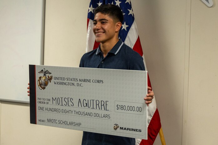 Moises Aguirre, a Hendrickson High School student, poses for a picture after being presented the Naval Reserve Officer Training Corps scholarship at Hendrickson High School in Pflugerville, Texas, Jan. 15, 2025. Students selected for this prestigious scholarship program must uphold strict physical standards and successfully complete additional military courses while maintaining normal college coursework responsibilities. (U.S. Marine Corps photo by Cpl. Jose D. Cruz)