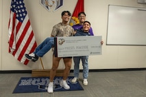 Moises Aguirre and students from Hendrickson High School, pose for a photo after the presentation of the Naval Reserve Officer Training Corps scholarship at Hendrickson High School in Pflugerville, Texas, Jan. 15, 2025. Students selected for this prestigious scholarship program must uphold strict physical standards and successfully complete additional military courses while maintaining normal college coursework responsibilities. (U.S. Marine Corps photo by Cpl. Jose D. Cruz)