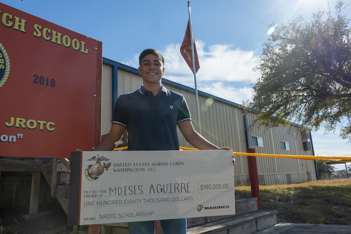 Moises Aguirre, a student from Hendrickson High School, poses for a picture after the presentation of the Naval Reserve Officer Training Corps scholarship at Hendrickson High School in Pflugerville, Texas, Jan. 15, 2025. Students selected for this prestigious scholarship program must uphold strict physical standards and successfully complete additional military courses while maintaining normal college coursework responsibilities. (U.S. Marine Corps photo by Cpl. Jose D. Cruz)