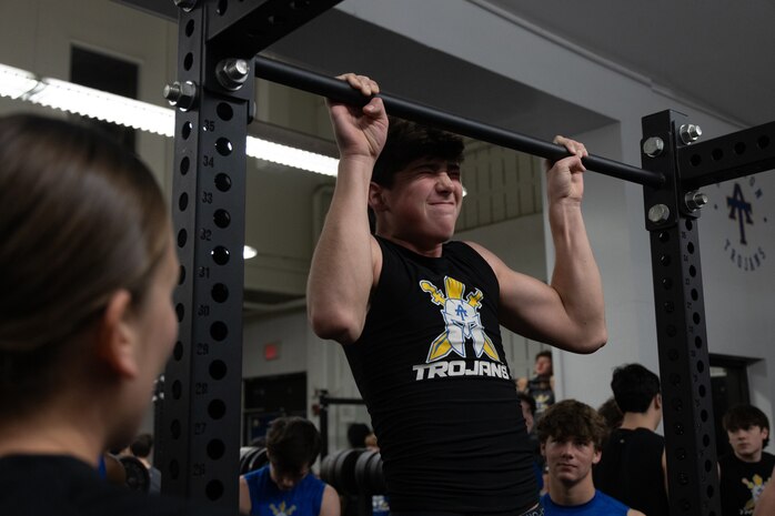 U.S. Marine Corps Capt. Brianna K. LeCompte, the executive officer of Recruiting Station Austin, supervises as a student of Anderson High School conducts a pull up during the Initial Strength Assessment at Anderson High School in Austin, Texas, Jan. 15, 2025. During the visit, Marines hosted an Initial Strength Assessment with Anderson High School students. (U.S. Marine Corps photo by Cpl. Jose D. Cruz)