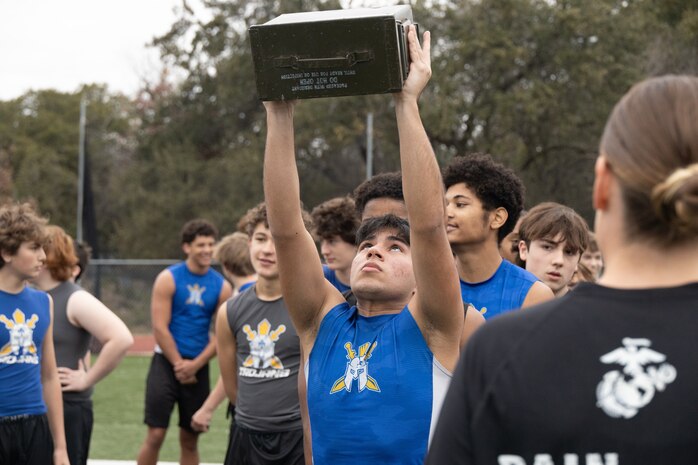 U.S. Marine Corps Capt. Brianna K. LeCompte, the executive officer of Recruiting Station Austin, supervises as a student of Anderson High School conducts ammunition can lifts during a school visit at Anderson High School in Austin, Texas, Jan. 15, 2025. During this visit, the Marines conducted an Initial Strength Assessment with Anderson High School students. (U.S. Marine Corps photo by Cpl. Jose D. Cruz)